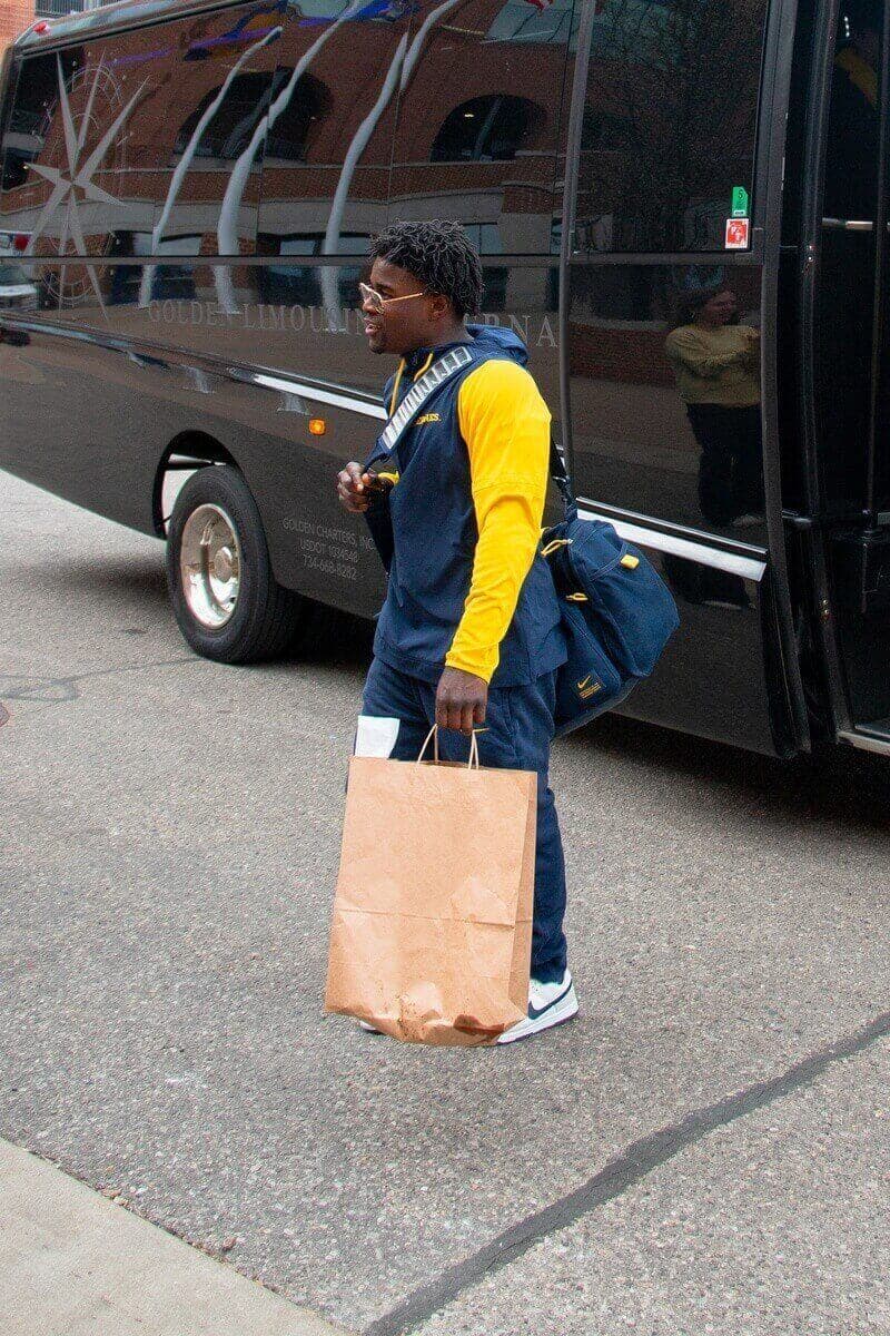 Michigan gymnast traveling with team equipment and gear